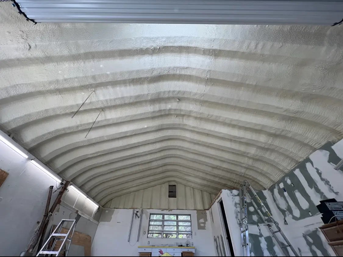 Spray polyurethane foam applied to the underside of a metal roof deck in Pacifica